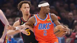 Oklahoma City Thunder guard Shai Gilgeous-Alexander (2) spins away from Atlanta Hawks guard Dyson Daniels, left, during the first half of an NBA basketball game Monday, Dec. 29, 2025, in Oklahoma City. (Nate Billings/AP)