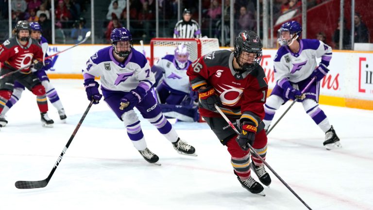 Ottawa Charge's Katerina Mrazova (16) works to keep the puck in the offensive zone as Minnesota Frost's Abby Hustler (74) defends, during first period PWHL hockey action in Ottawa, on Tuesday, Dec. 2, 2025. (Justin Tang/CP)