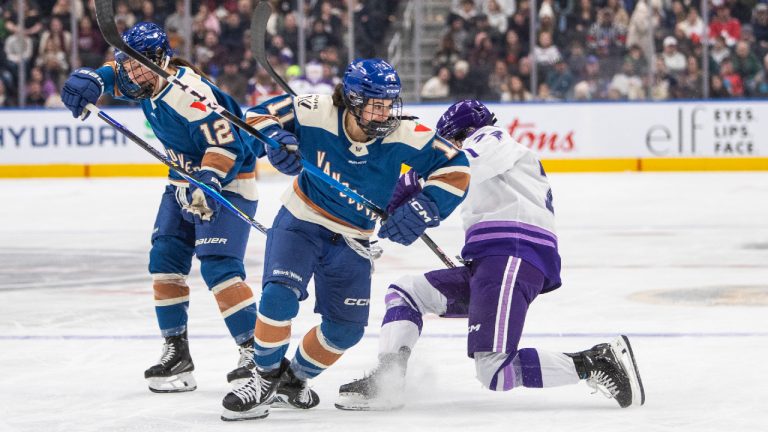 Minnesota Frost Abby Hustler (74) battles Vancouver Goldeneyes Sydney Bard (11) and Jennifer Gardiner (12) during first period PWHL action in Edmonton on Saturday December 27, 2025. (Amber Bracken/CP)