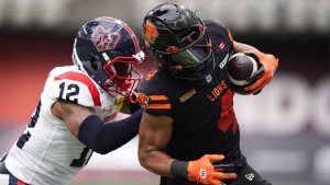B.C. Lions' Keon Hatcher (4) is shoved by Montreal Alouettes' Najee Murray (12) after making a reception during the first half of a CFL football game, in Vancouver, on Saturday, August 16, 2025. (Darryl Dyck/THE CANADIAN PRESS)