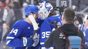 Toronto Maple Leafs' Auston Matthews (34) congratulates Toronto Maple Leafs goaltender Dennis Hildeby (35) after his shut out in their team's 2-0 win over Tampa Bay Lightning NHL hockey action in Toronto, Monday, Dec. 8, 2025. (Chris Young/THE CANADIAN PRESS)