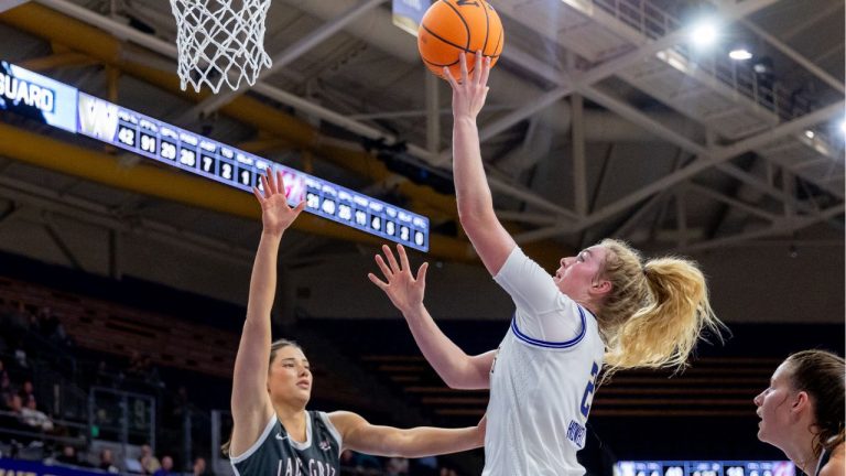 Washington's Avery Howell, right, goes in for a basket. (UW Athletics)