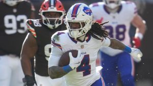 Buffalo Bills running back James Cook III (4) runs the ball for a touchdown against the Cleveland Browns during the first half of an NFL football game in Cleveland, Sunday, Dec. 21, 2025. (Sue Ogrocki/AP)