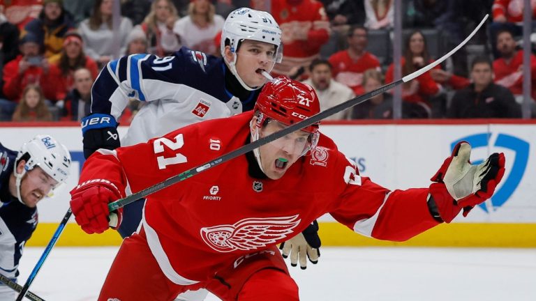 Detroit Red Wings left wing James van Riemsdyk (21) reacts after getting tangled up with Winnipeg Jets centre Cole Perfetti, left, during the second period of an NHL hockey game, Wednesday, Dec. 31, 2025, in Detroit. (Duane Burleson/AP Photo)
