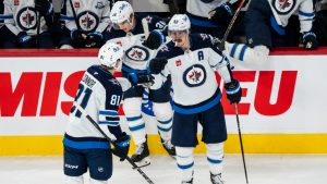 Winnipeg Jets' Mark Scheifele (55) celebrates his goal with teammate Kyle Connor (81) during first period NHL hockey action against the Montreal Canadiens in Montreal on Wednesday, Dec. 3, 2025. (Christopher Katsarov/CP)