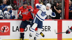Toronto Maple Leafs centre Scott Laughton (24) and Washington Capitals left wing Alex Ovechkin (8) collide along the boards during the first period of an NHL hockey game, Thursday, Dec. 18, 2025, in Washington. (Nick Wass/AP)