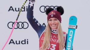 United States' Lindsey Vonn celebrates on the podium after taking third place in an alpine ski, women's World Cup super-G in Val d'Isere, France, Sunday, Dec. 21, 2025. (Giovanni Auletta/AP)