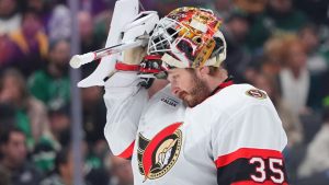 Ottawa Senators goaltender Linus Ullmark adjusts his helmet during the first period of an NHL hockey game against the Dallas Stars, Sunday, Nov. 30, 2025, in Dallas. (LM Otero/AP)