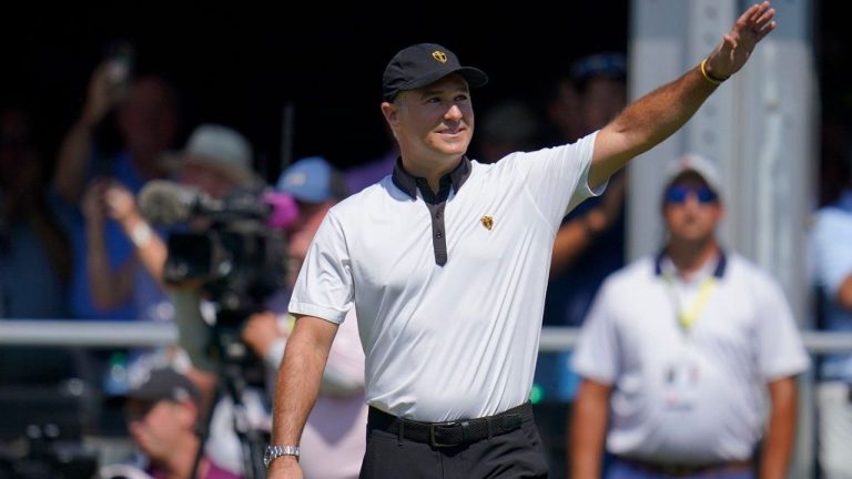 International team captain Trevor Immelman waves toward the gallery before a foursomes match at the Presidents Cup golf tournament at the Quail Hollow Club, Sept. 22, 2022, in Charlotte, N.C. (Julio Cortez/AP)