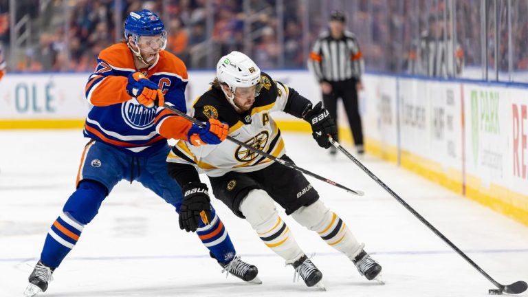 Boston Bruins' David Pastrnak (88) battles for the puck against Edmonton Oilers' Connor McDavid (97) during third period NHL action in Edmonton on Thursday, December 19, 2024. (Timothy Matwey/CP)