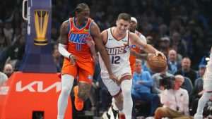 Phoenix Suns guard Collin Gillespie (12) pushes past Oklahoma City Thunder guard Jalen Williams (8) during the first half of an NBA Cup basketball game, Wednesday, Dec. 10, 2025, in Oklahoma City. (Kyle Phillips/AP)