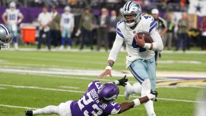 Dallas Cowboys quarterback Dak Prescott (4) breaks a tackle by Minnesota Vikings cornerback Andrew Booth Jr. (23) during the first half of an NFL football game. (Bruce Kluckhohn/AP)