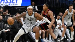 Orlando Magic forward Paolo Banchero (5) is defended by Toronto Raptors forward Scottie Barnes during the second half of an NBA basketball game, Tuesday, March 4, 2025, in Orlando, Fla. (Phelan M. Ebenhack/AP)