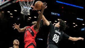 Brooklyn Nets guard Nolan Traore (88) blocks Toronto Raptors guard Immanuel Quickley (5) during the first half of an NBA basketball game, Sunday, Dec. 21, 2025, in New York. (Yuki Iwamura/AP)