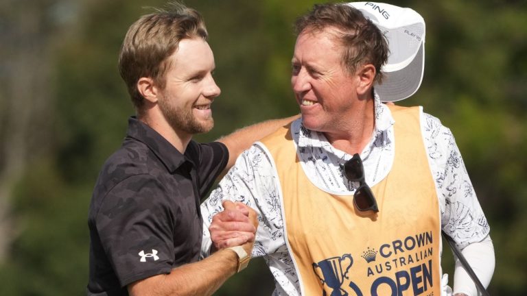 Denmark's Rasmus Neergaard-Petersen, left, celebrates with his caddy Brian Nilsson winning the Australian Open golf tournament in Melbourne, Australia, Sunday, Dec. 7, 2025. (Asanka Brendon Ratnayake/AP)
