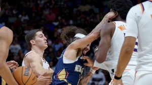 New Orleans Pelicans guard Jose Alvarado (15) and Phoenix Suns centre Mark Williams (15) get into a scrum during the third quarter before both were ejected during an NBA basketball game in New Orleans, Saturday, Dec. 27, 2025. (Matthew Hinton/AP)