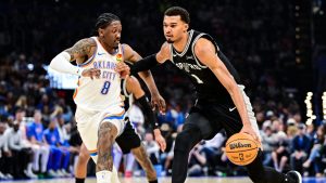 San Antonio Spurs Victor Wembanyama (1) drives against Oklahoma City Thunder guard/forward Jalen Williams (8) during the first half of an NBA basketball game, Thursday, Dec. 25, 2025, in Oklahoma City. (Gerald Leong/AP Photo)