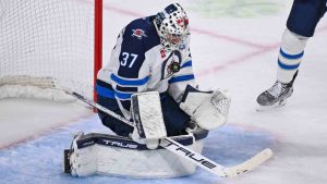 Winnipeg Jets goaltender Connor Hellebuyck (37) stops a Minnesota Wild shot during the second period of an NHL hockey game Thursday, Jan. 15, 2025, in St. Paul, Minn. (Craig Lassig/AP)