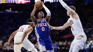Philadelphia 76ers' Tyrese Maxey (0) goes up for a shot against Cleveland Cavaliers' Sam Merrill (5) during the first half of an NBA basketball game Wednesday, Jan. 14, 2026, in Philadelphia. (AP Photo/Matt Slocum)