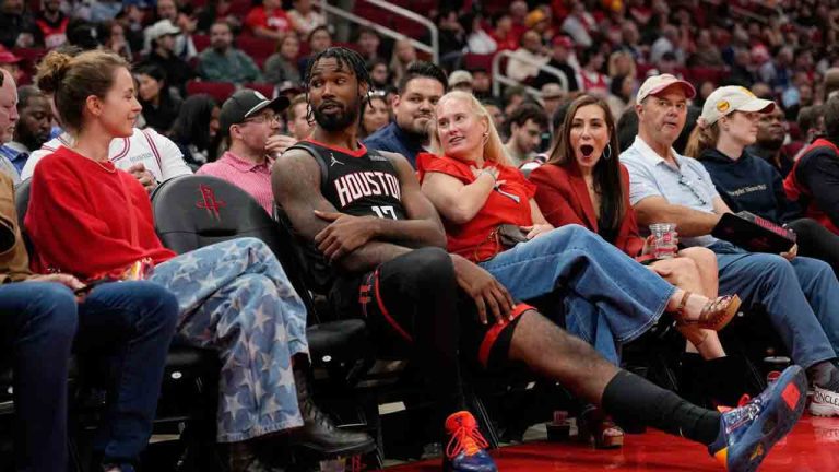 Houston Rockets forward Tari Eason (17) sits with fans during an extended officials timeout in the first half of an NBA basketball game against the Phoenix Suns Monday, Jan. 5, 2026, in Houston. (David J. Phillip/AP)