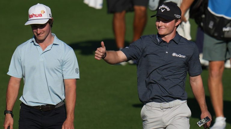 Blades Brown, right, reacts for a cheering gallery as he walks with David Ford as the gallery cheers for Brown who finished with a 12-under-par 60 during the second round of the American Express golf event at the Jack Nicklaus Tournament Course at PGA West Friday, Jan. 23, 2026, in La Quinta, Calif. (Ross D. Franklin/AP)