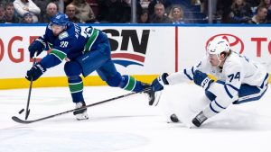 Vancouver Canucks' Marcus Pettersson (29) misses the empty net after Toronto Maple Leafs' Bobby McMann (74) lifts his stick during the third period of an NHL hockey game in Vancouver, on Saturday, February 8, 2025. IEthan Cairns/CP)