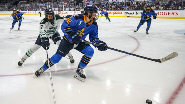 Boston Fleet's Theresa Schafzahl (37) and Toronto Sceptres' Allie Munroe (12) battle for control of the puck during third period PWHL hockey action in Toronto on Friday Feb. 14, 2025. THE CANADIAN PRESS/Arlyn McAdorey