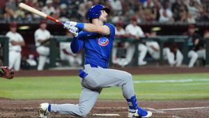 Chicago Cubs' Kyle Tucker follows through with his swing against the Arizona Diamondbacks during the fourth inning of an opening-day baseball game Thursday, March 27, 2025, in Phoenix. (Ross D. Franklin/AP)