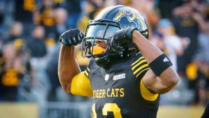 Hamilton Tiger Cats wide receiver Tim White (12) celebrates his touchdown during the first half of the CFL Hamilton Tiger Cats home opener against the Saskatchewan Roughriders in Hamilton, Ont., on Saturday, June 14, 2025. (Peter Power/CP)