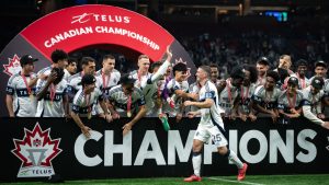 Vancouver Whitecaps' Ryan Gauld walks to a podium to hoist the Voyageurs Cup after defeating Vancouver FC in the Canadian Championship final match, in Vancouver, on Wednesday, October 1, 2025. (Ethan Cairns/CP)
