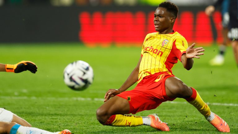 Lens' Mamadou Sangare slides for the ball during the French League One match between Lens and Marseille in Lens, France, Saturday, Oct. 25, 2025. (Jean-Francois Badias/AP)