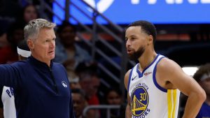 Golden State Warriors head coach Steve Kerr talks with guard Stephen Curry (30) during the first quarter of an NBA basketball game against the New Orleans Pelicans, Sunday, Nov. 16, 2025, in New Orleans. (Butch Dill/AP)