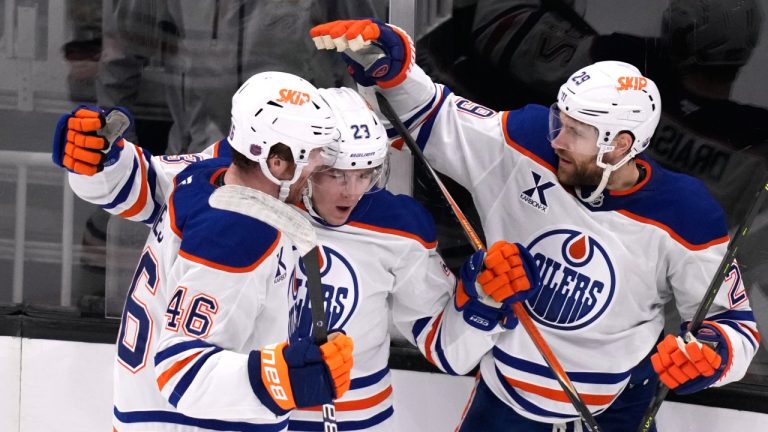 Edmonton Oilers right wing Quinn Hutson, center, is congratulated after his goal against the Boston Bruins during the second period of an NHL hockey game, Thursday, Dec. 18, 2025, in Boston. (AP Photo/Charles Krupa)