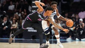 Miami Heat forward Myron Gardner (15) lunges to defend as Minnesota Timberwolves guard Anthony Edwards drives forward during the second half of an NBA basketball game, Saturday, Jan. 3, 2026, in Miami. (AP Photo/Rebecca Blackwell)