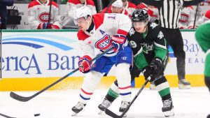 Montréal Canadiens right wing Brendan Gallagher (11) and Dallas Stars center Justin Hryckowian (49) skate for the puck during the second period of an NHL hockey game Sunday, Jan. 4, 2026, in Dallas. (AP Photo/LM Otero)