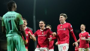 Wrexham's goalkeeper Arthur Okonkwo, left, celebrates with teammates after a penalty shootout at the end of the English FA Cup third round soccer match between Wrexham and Nottingham Forest in Wrexham, Wales, Friday, Jan. 9, 2026. (AP Photo/Jon Super)