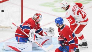 Montreal Canadiens goaltender Jacob Fowler (32) is scored on by Detroit Red Wings' Dylan Larkin (not shown) as Red Wings' James van Riemsdyk (21) and Canadiens' Mike Matheson look for a rebound during second period NHL hockey action in Montreal, Saturday, Jan. 10, 2026. (Graham Hughes/CP)