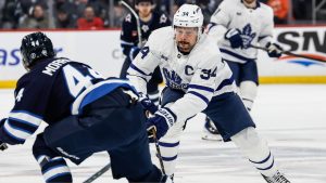 Winnipeg Jets' Josh Morrissey defends against Toronto Maple Leafs' Auston Matthews during first period NHL action in Winnipeg, Saturday, January 17, 2026. (John Woods/CP)