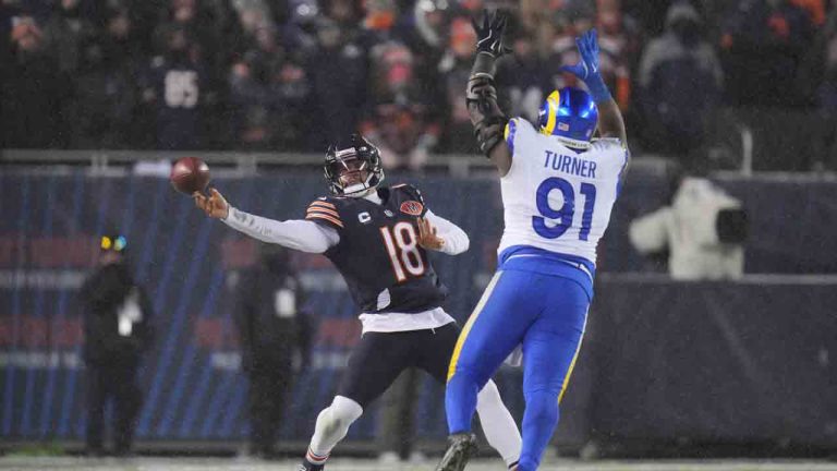 Chicago Bears quarterback Caleb Williams (18) throws a pass as Los Angeles Rams defensive end Kobie Turner (91) applies pressure during the second half of an NFL football divisional playoff game Sunday, Jan. 18, 2026, in Chicago. (Jeff Roberson/AP)