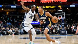 New Orleans Pelicans forward Trey Murphy III, right, drives against Memphis Grizzlies forward GG Jackson II (45) in the second half of an NBA basketball game Friday, Jan. 23, 2026, in Memphis, Tenn. (AP Photo/Brandon Dill)