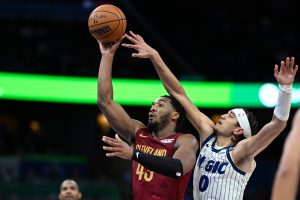 Cleveland Cavaliers guard Donovan Mitchell, second from right, goes up to shoot as Orlando Magic guard Anthony Black (0) defends during the second half of an NBA basketball game, Saturday, Jan. 24, 2026, in Orlando, Fla. (Phelan M. Ebenhack/AP)