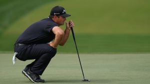 Patrick Reed of the United States lines up a putt on the 3rd green during the final round of the Dubai Desert Classic in United Arab Emirates, Sunday, Jan. 25, 2026. (AP Photo/Altaf Qadri)
