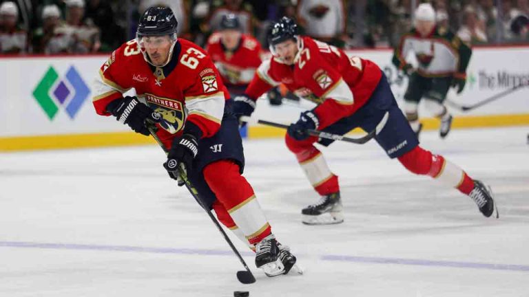 Florida Panthers' Brad Marchand (63) controls the puck against the Minnesota Wild during the second period of an NHL hockey game, Saturday, Jan. 24, 2026, in St. Paul, Minn. (Lily Dozier/AP)