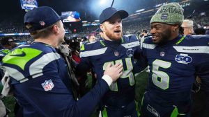 Seattle Seahawks quarterback Sam Darnold, center, celebrates with quarterback Jalen Milroe (6) quarterback Drew Lock, left, after the NFC Championship NFL football game Sunday, Jan. 25, 2026, in Seattle. (Lindsey Wasson/AP)