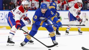 Buffalo Sabres center Peyton Krebs (19) is stick checked by Montréal Canadiens center Phillip Danault (24) during the first period of an NHL hockey game Saturday, Jan. 31, 2026, in Buffalo, N.Y. (Jeffrey T. Barnes/AP)