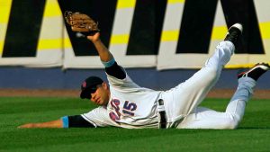 New York Mets center fielder Carlos Beltran comes up with the ball after making a sliding catch off Texas Rangers' Michael Young's fifth inning fly out in their baseball game at Shea Stadium in New York, Sunday, June 15, 2008. (Kathy Willens/AP)