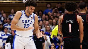 Duke's Cameron Boozer (12) claps in front of Louisville's J'Vonne Hadley (1) as a timeout is called during the first half of an NCAA college basketball game in Durham, N.C., Monday, Jan. 26, 2026. (Ben McKeown/AP)