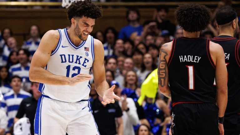 Duke's Cameron Boozer (12) claps in front of Louisville's J'Vonne Hadley (1) as a timeout is called during the first half of an NCAA college basketball game in Durham, N.C., Monday, Jan. 26, 2026. (Ben McKeown/AP)