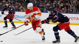 Calgary Flames' Matt Coronato, left, tries to skate past Columbus Blue Jackets' Adam Fantilli during the first period of an NHL hockey game, Tuesday, Jan. 13, 2026, in Columbus, Ohio. (Jay LaPrete/AP)
