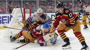 Florida Panthers center Sam Reinhart (13) and New York Rangers left wing Will Cuylle (50) fall into New York Rangers goaltender Igor Shesterkin (31) during the first period of the NHL Winter Classic outdoor hockey game, Friday, Jan. 2, 2026, in Miami. (Lynne Sladky/AP)